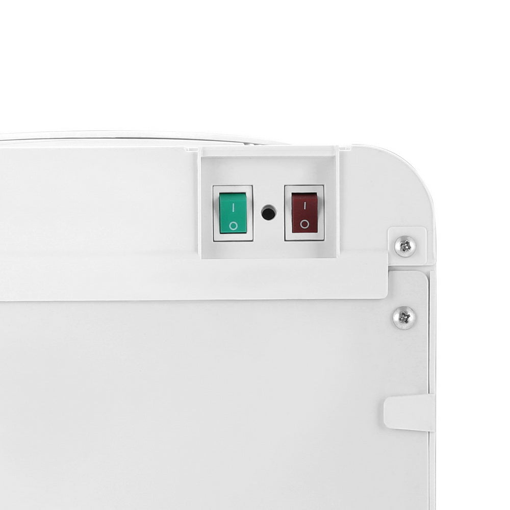 Close-up of a white electronic device with green and red indicator lights on a white background